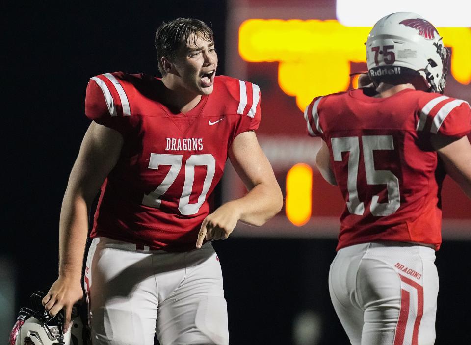 New Palestine Dragons offensive lineman Ian Moore (70) yells in excitement on Friday, August 19, 2022 at New Palestine High School in New Palestine. New Palestine Dragons defeated the Westfield Shamrocks, 48-28.