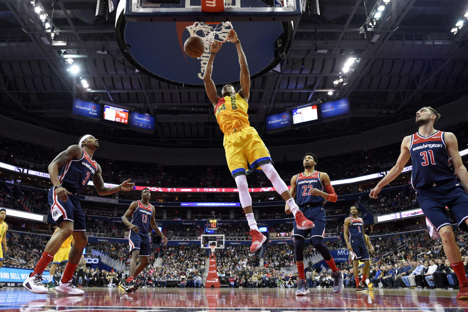 Milwaukee Bucks forward Giannis Antetokounmpo (34) dunks against Washington Wizards guard Bradley Beal (3), center Thomas Bryant (13), guard Tomas Satoransky (31), Trevor Ariza (1) and forward Otto Porter Jr. (22) during the first half of an NBA basketball game, Saturday, Feb. 2, 2019, in Washington. The Bucks won 131-115. (AP Photo/Nick Wass)