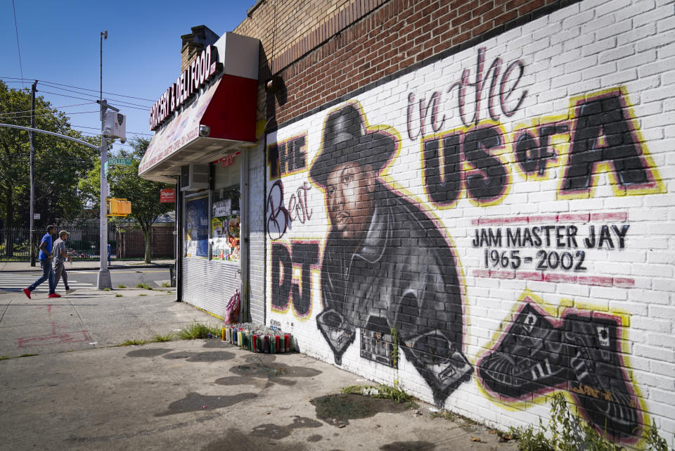 FILE - Pedestrians pass a mural, by artist Art1Airbrush, of rap pioneer Jam Master Jay of Run-DMC, Tuesday, Aug. 18, 2020, in the Queens borough of New York. Opening statements are set for Monday in the federal murder trial of Karl Jordan Jr. and Ronald Washington, who were arrested in 2020 for the murder of Jam Master Jay. (AP Photo/John Minchillo, File)