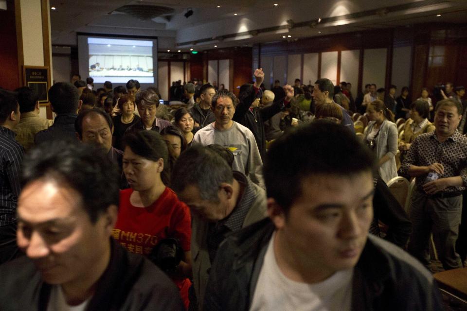 Parientes de pasajeros del avión perdido de Malaysia Airlines se retiran de una videoconferencia con las autoridades malasias en protesta por las dificultades de las comunicaciones en Beijing, China, el miércoles 16 de abril de 2014. (AP Foto/Ng Han Guan)