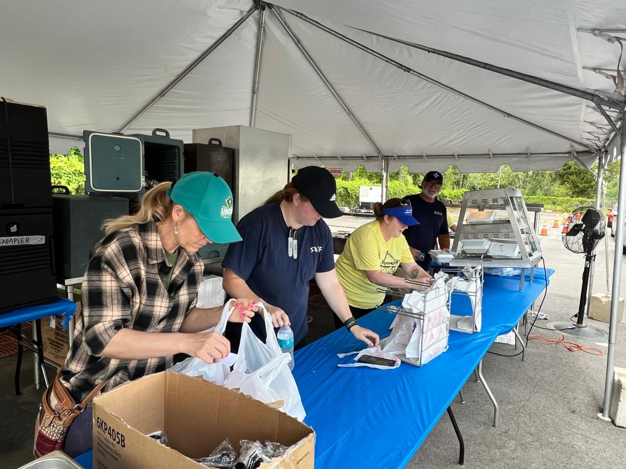 Workers prepare to-go orders for the drive-thru at the Wilmington Greek Festival at St. Nicholas Greek Orthodox Church on Saturday, May 20, 2023.
