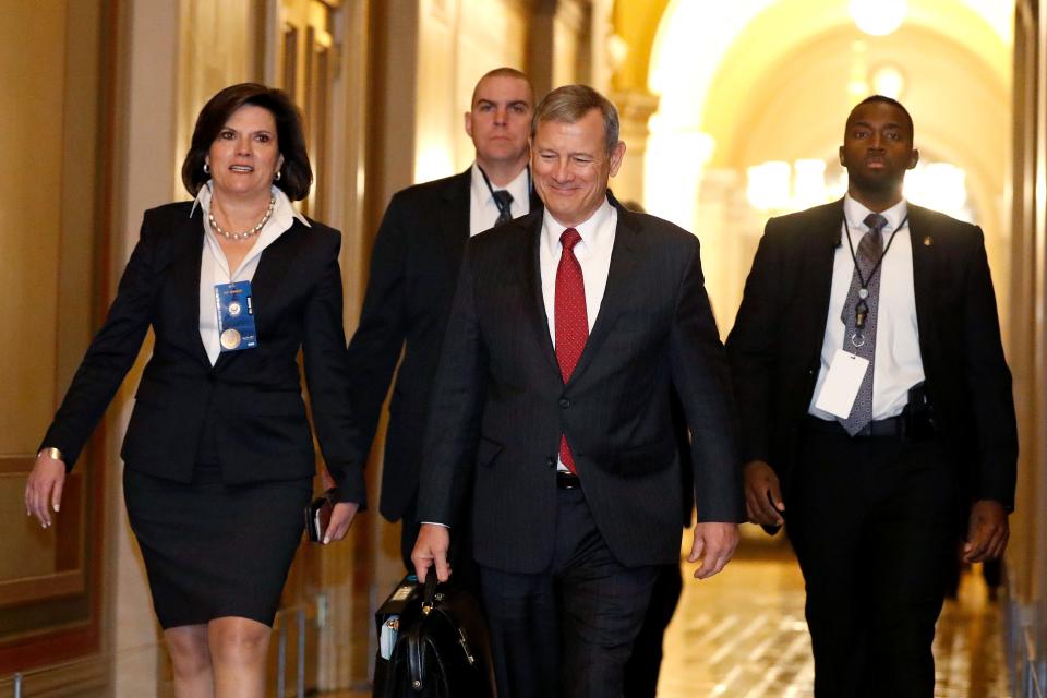 Supreme Court Chief Justice John Roberts, second from right, arrives at the Capitol in Washington during the impeachment trial of President Donald Trump on Friday.