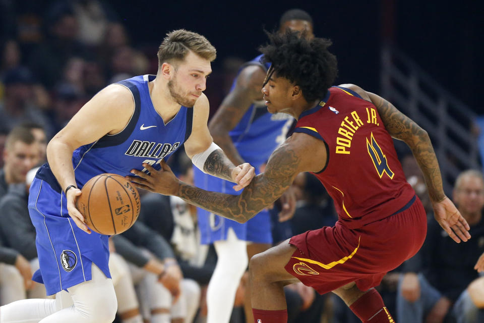 Dallas Mavericks' Luka Doncic drives against Cleveland Cavaliers' Kevin Porter Jr. in the first half of an NBA basketball game, Sunday, Nov. 3, 2019, in Cleveland. (AP Photo/Ron Schwane)