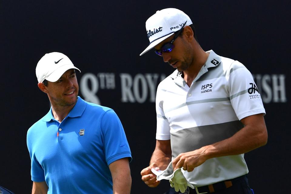 Northern Ireland's Rory McIlroy (L) and Spain's Rafael Cabrera-Bello walk down the fairway from the first hole during a practice session at The 148th Open golf Championship at Royal Portrush golf club in Northern Ireland on July 16, 2019. (Photo by Paul ELLIS / AFP) / RESTRICTED TO EDITORIAL USE        (Photo credit should read PAUL ELLIS/AFP/Getty Images)