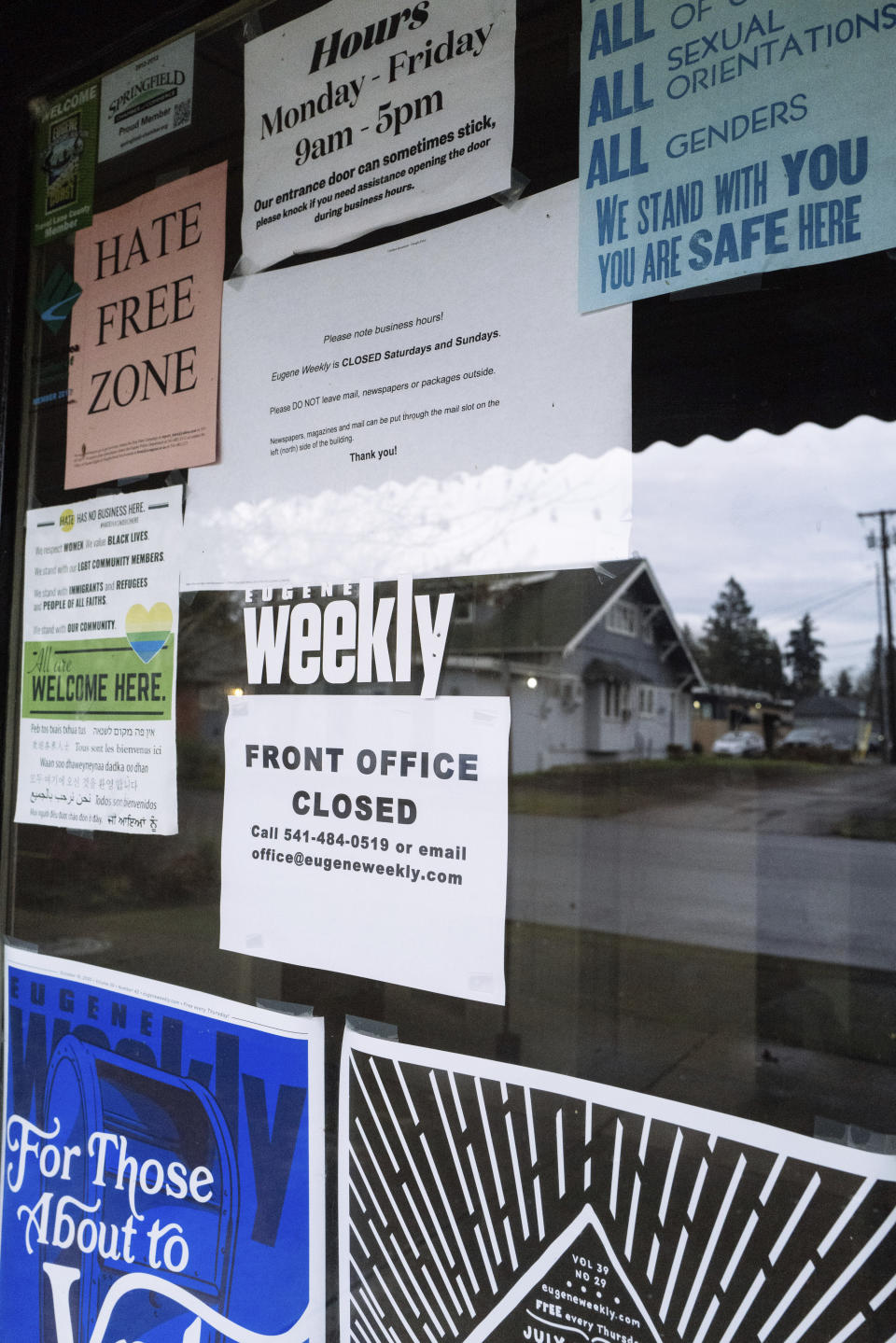 Signs, including one that reads "front office closed," are taped to the door of the office of Eugene Weekly in Eugene, Ore., on Friday, Dec. 29, 2023. The weekly newspaper had to lay off its entire staff three days before Christmas and halt print because its funds were embezzled by a former employee, its editor said. The Eugene police are investigating and the paper's owners have hired forensic accountants to piece together what happened. (Todd Cooper via AP)