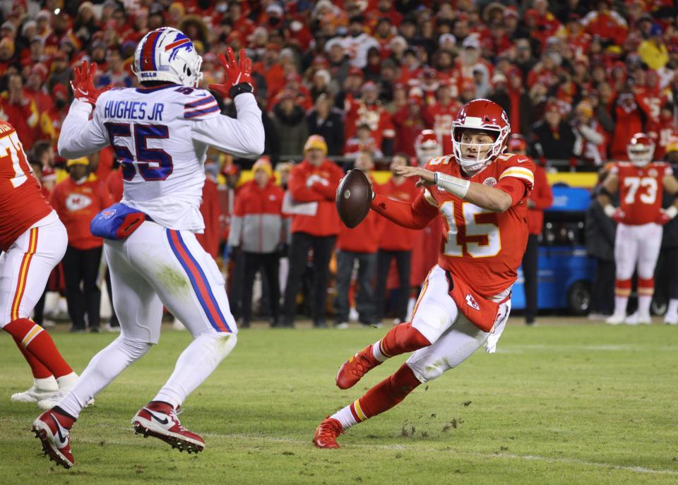 Chiefs Patrick Mahomes runs around Bills Jerry Hughes. 