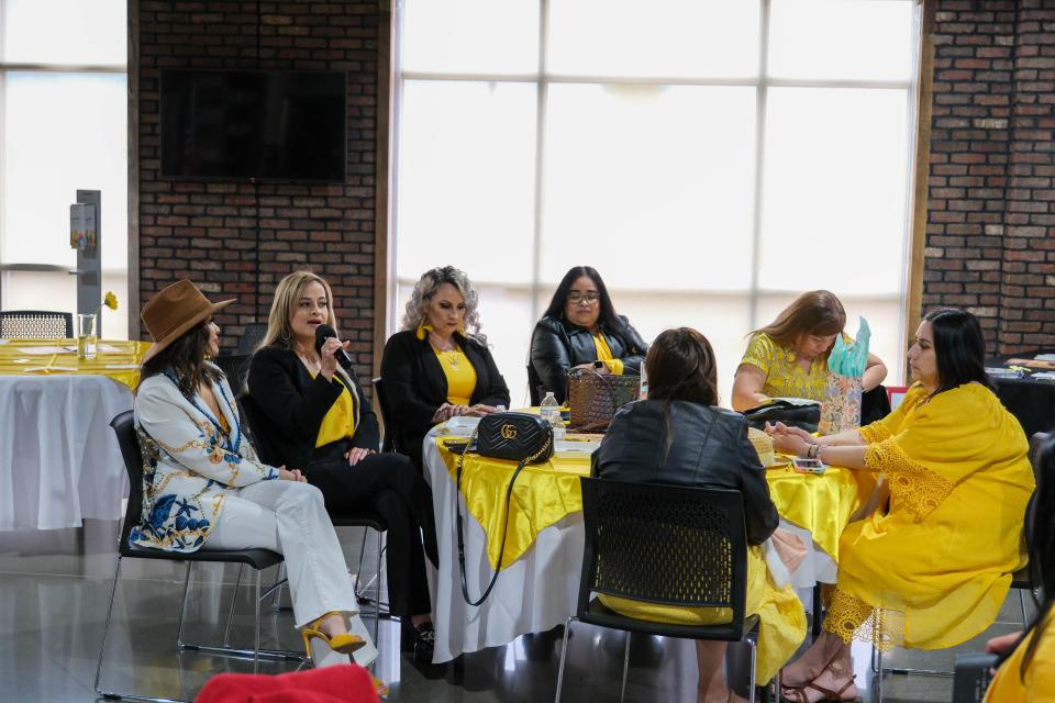 A an attendee shares her story at AM de Amarillo's Mujeres de Amarillo (women in yellow) event last weekend in east Amarillo.