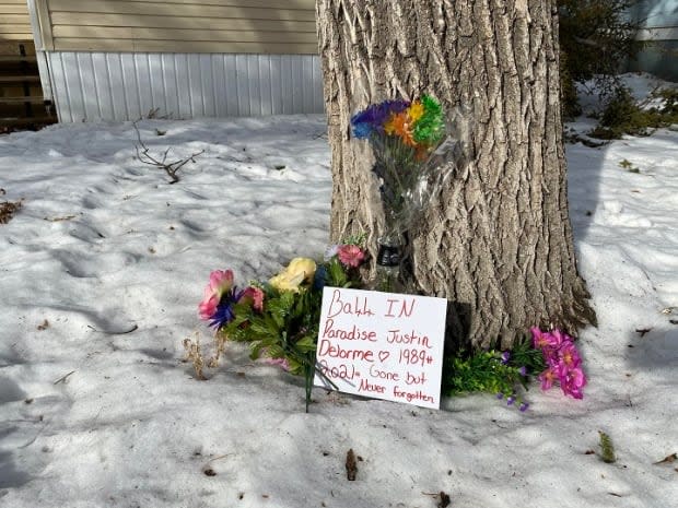 A memorial has been created at a home on the 1000 block of Garnet Street in memory of Justin Robert Delorme, 32, of Regina. Delorme is the victim of the city's third homicide of 2021.  (Kirk Fraser/CBC - image credit)