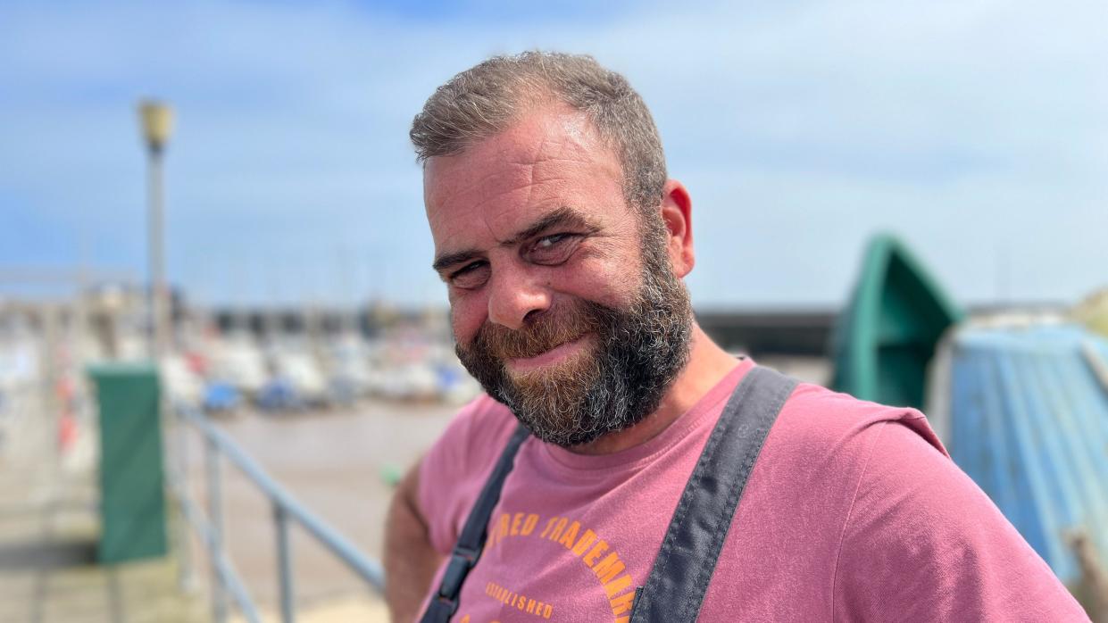 Fisherman Peter Sanderson stands near the boats at Bridlinglton harbour