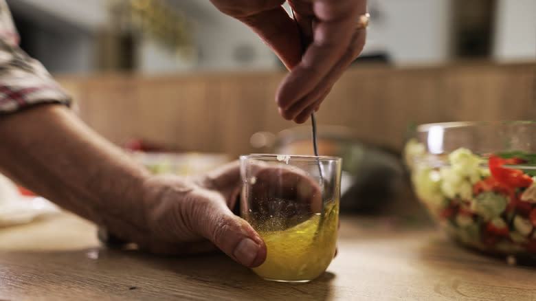 Mixing salad dressing in cup