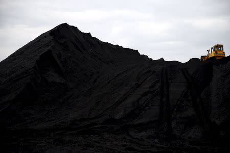A bulldozer works on a heap of coal at the Boleslaw Smialy coal mine, a unit of coal miner Kompania Weglowa (KW) in Laziska Gorne, Silesia, southern Poland September 11, 2015. REUTERS/Kacper Pempel/Files