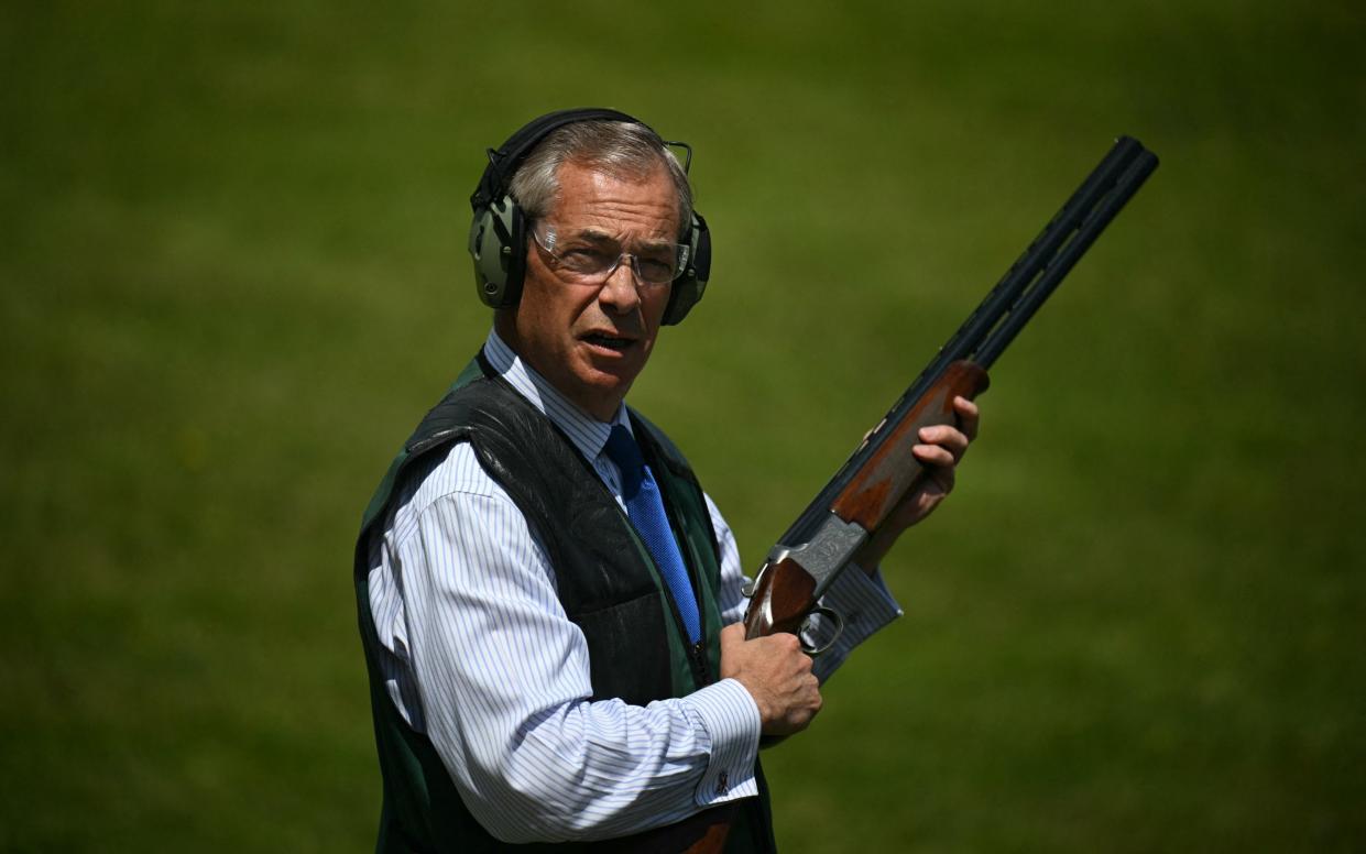 Nigel Farage, the Reform leader, tests a gun at a clay pigeon shooting range at Frodsham, Cheshire