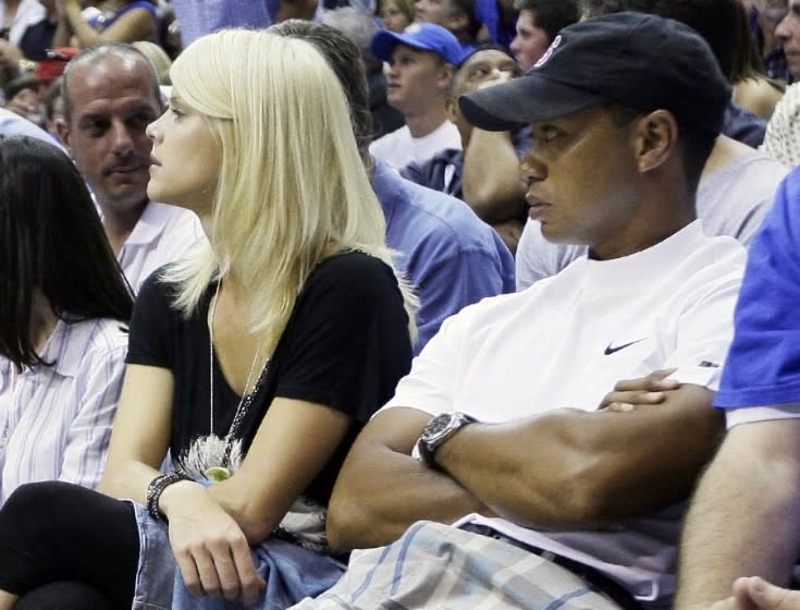 On June 11, 2009, Tiger Woods and his wife, Elin Nordegren watch the fourth quarter of Game 4 of the NBA basketball finals