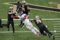 New Orleans Saints quarterback Derek Carr (4) throws a pass as he is pressured by Tennessee Titans defensive tackle Jeffery Simmons (98) in the second half of an NFL football game in New Orleans, Sunday, Sept. 10, 2023. (AP Photo/Gerald Herbert)