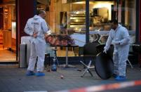 Police forensic experts work outside where a 21-year-old Syrian refugee killed a woman with a machete and injured two other people in the city of Reutlingen, Germany July 24, 2016. REUTERS/Vincent Kessler