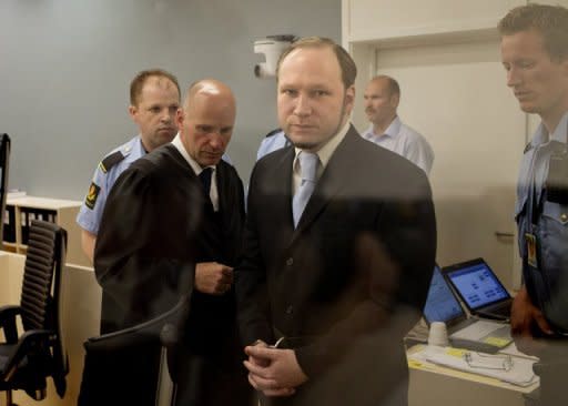 In this picture taken through bullet-proof glass, mass killer Anders Behring Breivik arrives for his trial in room 250 of Oslo's central court on Thursday. Breivik, who killed 77 people in Norway last July, should be locked up in a psychiatric ward instead of prison, the prosecution said Thursday, arguing his sanity had not been proven beyond a reasonable doubt