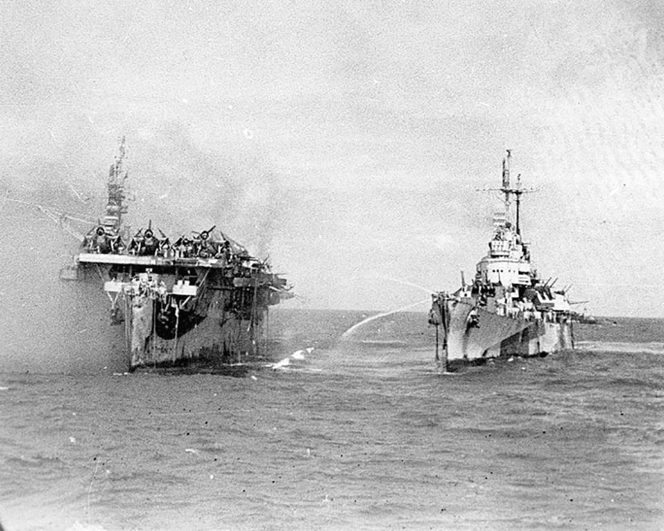 A photo of the USS Birmingham, right, assisting the burning USS Princeton.