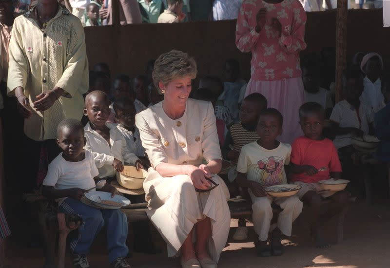 FILE PHOTO: Diana, Princess of Wales, sits among children at Nemazuva primary school in southeast Zimbabwe