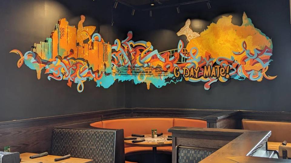 Multiple Australian-themed murals adorn the walls at Outback Steakhouse.