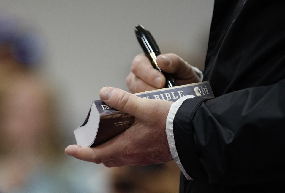 President Donald Trump signs a Bible as he greets people at Providence Baptist Church in Smiths Station, Ala., Friday, March 8, 2019, as they travel to tour areas where tornados killed 23 people in Lee County, Ala. (AP Photo/Carolyn Kaster)