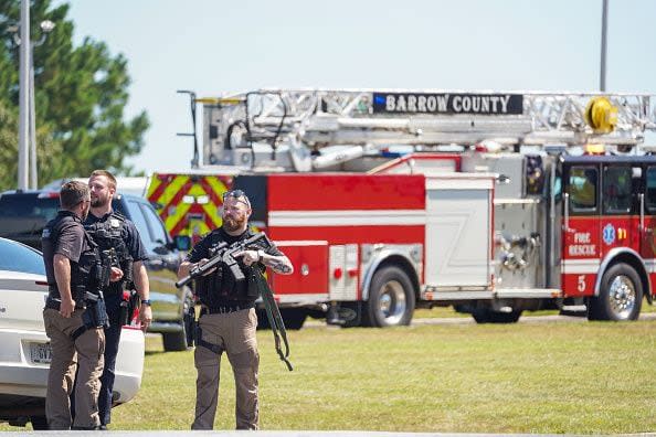 WINDER, GEORGIA - SEPTEMBER 4: Officers hold guns while talking outside after a shooting at Apalachee High School on September 4, 2024 in Winder, Georgia. Four fatalities and multiple injuries have been reported, and a 14-year-old suspect is in custody according to authorities. (Photo by Megan Varner/Getty Images)