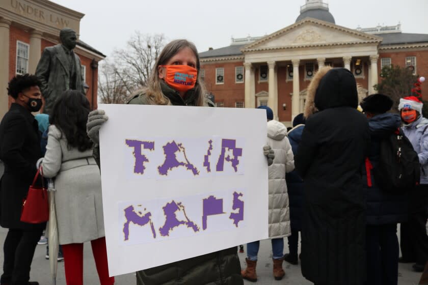 Amanda SubbaRao holds a sign calling for "Fair Maps" during a rally in Annapolis, Md., on Wednesday, Dec. 8, 2021. She was attending a rally opposing gerrymandering, in which politicians draw districts to benefit their party. The Maryland General Assembly is in a special session to approve a new congressional map for the state's eight U.S. House seats after the recent census. (AP Photo/Brian Witte)