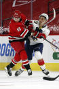 Carolina Hurricanes' Martin Necas (88) collides with Florida Panthers' Mason Marchment (19) during the first period of an NHL hockey game in Raleigh, N.C., Sunday, March 7, 2021. (AP Photo/Karl B DeBlaker)