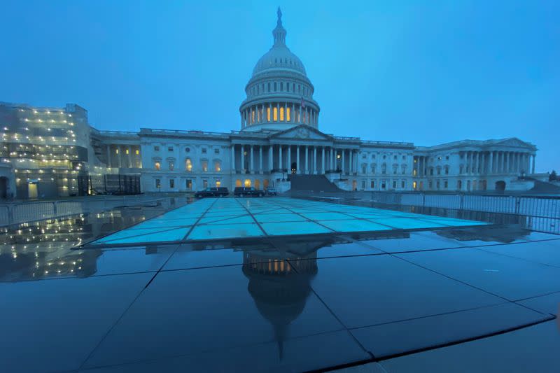 The U.S. Capitol dome is shrouded in early-morning mist in Washington