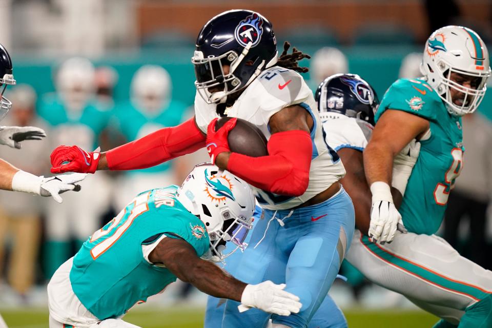 Dolphins linebacker David Long tackles ex-teammate Derrick Henry of the Titans.