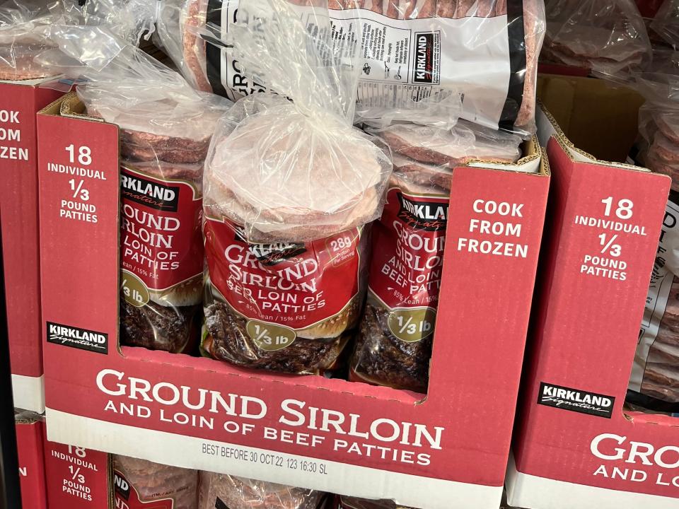Bags of frozen burgers in red boxes at Costco