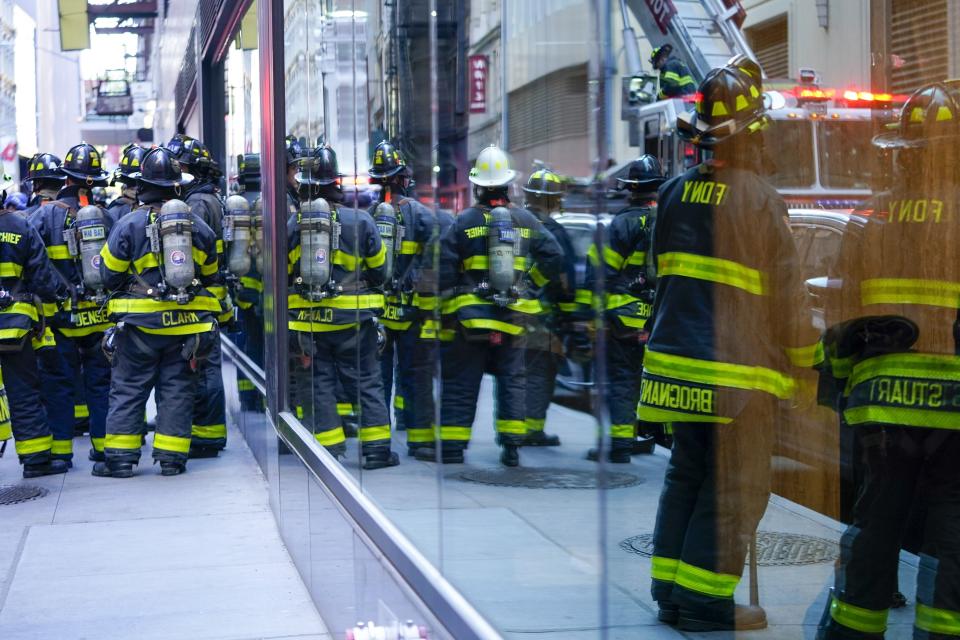 Firefighters work at the scene of a partial collapse of a parking garage in the Financial District of New York, Tuesday, April 18, 2023. (AP Photo/Mary Altaffer)