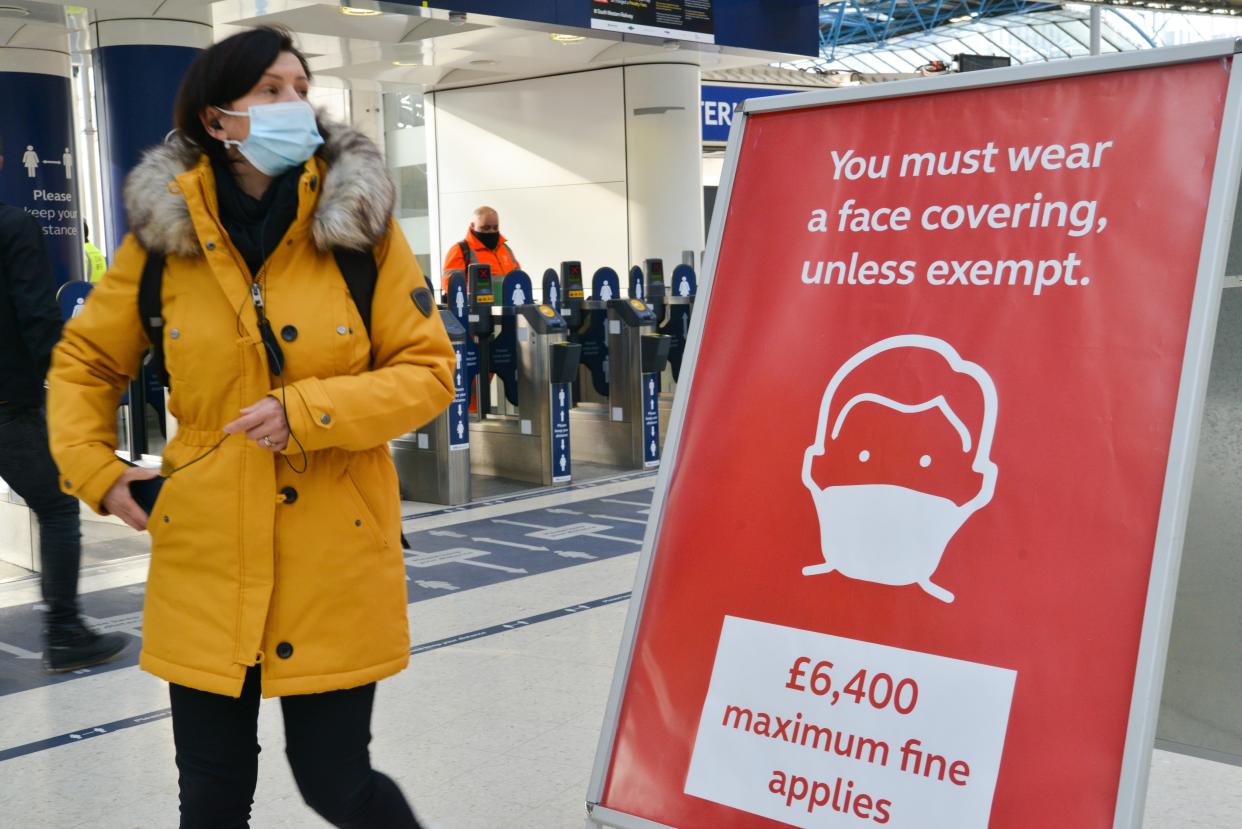  Commuter wearing a face mask walks past a sign reminding the public about a fine for not wearing a face mask, after arriving at London Waterloo railway station in London.
Prime Minister Boris Johnson announced that there was evidence that the new variant of the coronavirus is more deadly. (Photo by Thomas Krych / SOPA Images/Sipa USA) 