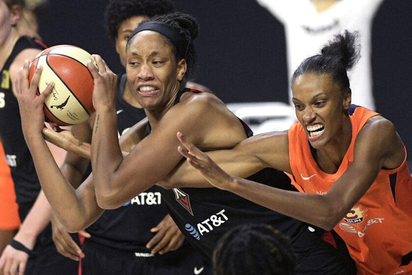 Las Vegas Aces center A'ja Wilson, left, grabs a rebound away from Connecticut Sun forward DeWanna Bonner during the second half of Game 5 of a WNBA basketball semifinal round playoff series, Tuesday, Sept. 29, 2020, in Bradenton, Fla. (AP Photo/Phelan M. Ebenhack)