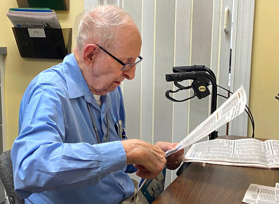 Bob Kruger comes to NC Reading Services every Wednesday and spends several hours reading newspapers over his broadcast, clipping each article by hand, so the blind and visually impaired can tune in.