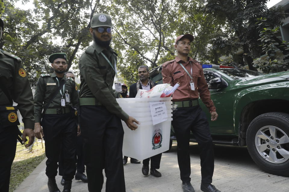 Security officers carry ballot boxes for distribution in Dhaka, Bangladesh,Saturday, Jan. 6, 2024. An apparent arson fire on a train in Bangladesh’s capital killed four people late Friday and added to the country’s extreme tension ahead of Sunday’s parliamentary elections that the opposition is seeking to boycott and disrupt with a general strike. (AP Photo/Mahmud Hossain Opu)