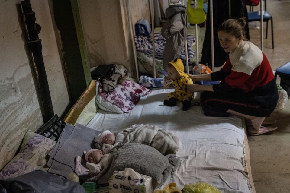 KYIV, UKRAINE - FEBRUARY 28: A mother tends to her baby while watching over twins that are under medical treatment in the bomb shelter of the paediatric ward of Okhmatdyt Children's Hospital on February 28, 2022 in Kyiv, Ukraine. As Russiaâ€™s large-scale invasion of Ukraine entered its fifth day, the capital was quieter overnight but Russian forces continued to mass outside the city. Ukrainian forces waged battle to hold other major cities. (Photo by Chris McGrath/Getty Images)