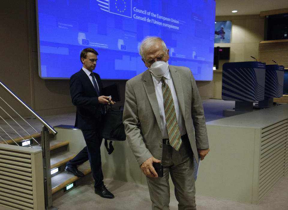 European Union foreign policy chief Josep Borrell, right, wears a mouth mask after addressing a video press conference at the conclusion of a video conference of EU foreign affairs ministers in Brussels, Wednesday, April 22, 2020. (Olivier Hoslet, Pool Photo via AP)