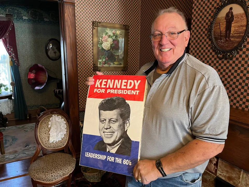 Randy Feemster of New Philadelphia poses with a campaign poster for President John F. Kennedy. When Feemster was 11, he met Kennedy in 1960 at a campaign event in Canton.