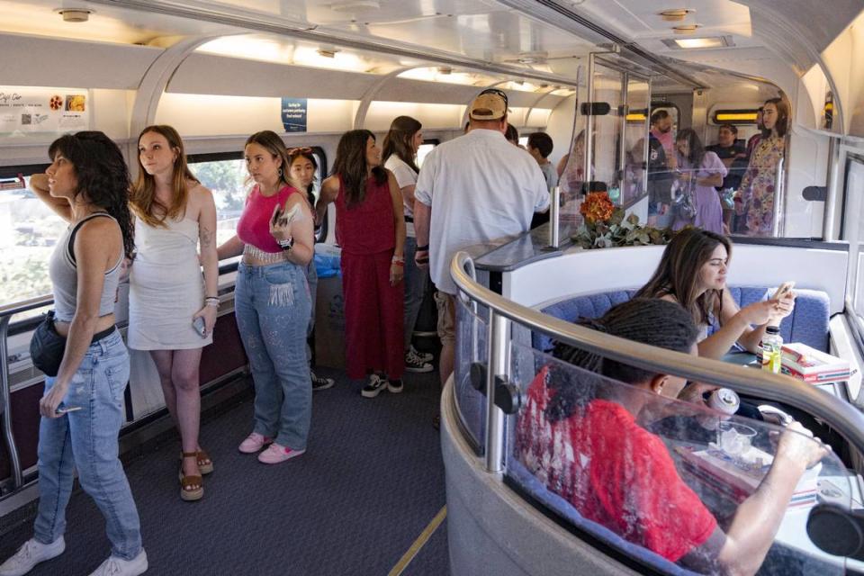 People wait in line for food and drinks on Friday, July 28, 2023, during the three-hour train trip from Sacramento to Levi’s Stadium for the Taylor Swift concert.