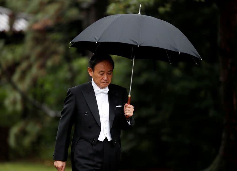 Japan's Chief Cabinet Secretary Yoshihide Suga arrives at the ceremony site where Emperor Naruhito will report the conduct of the enthronement ceremony at the Imperial Sanctuary inside the Imperial Palace in Tokyo