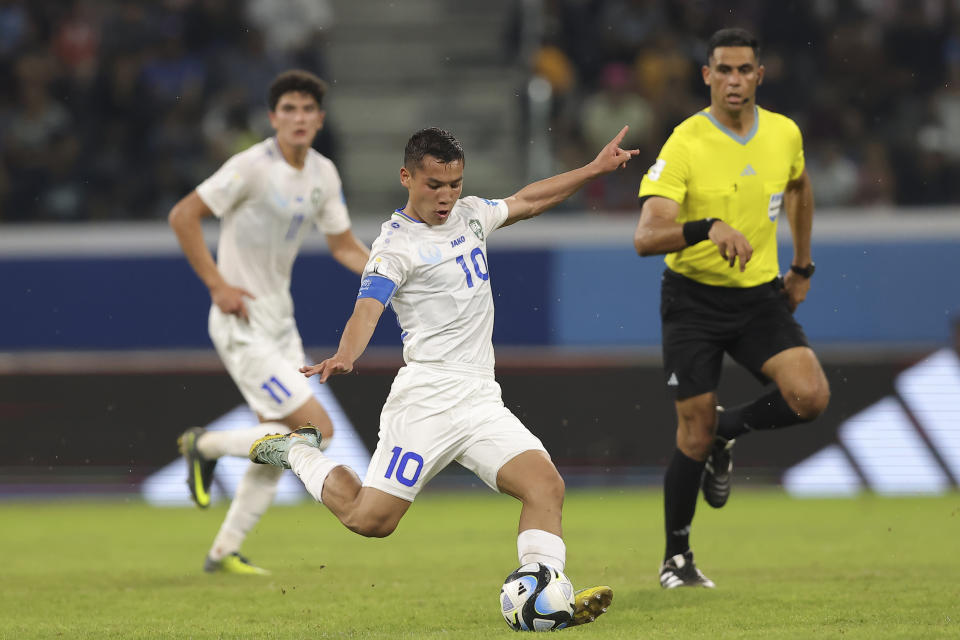 Uzbekistan's Umarali Rakhmonaliev strikes the ball against Guatemala during a FIFA U-20 World Cup Group A soccer match at the Madre De Ciudades stadium in Santiago del Estero, Argentina, Friday, May 26, 2023. (AP Photo/Nicolas Aguilera)