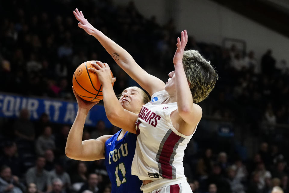 Florida Gulf Coast's Maddie Antenucci, left, goes up for a shot against Washington State's Astera Tuhina during the second half of a first-round college basketball game in the NCAA Tournament, Saturday, March 18, 2023, in Villanova, Pa. (AP Photo/Matt Rourke)