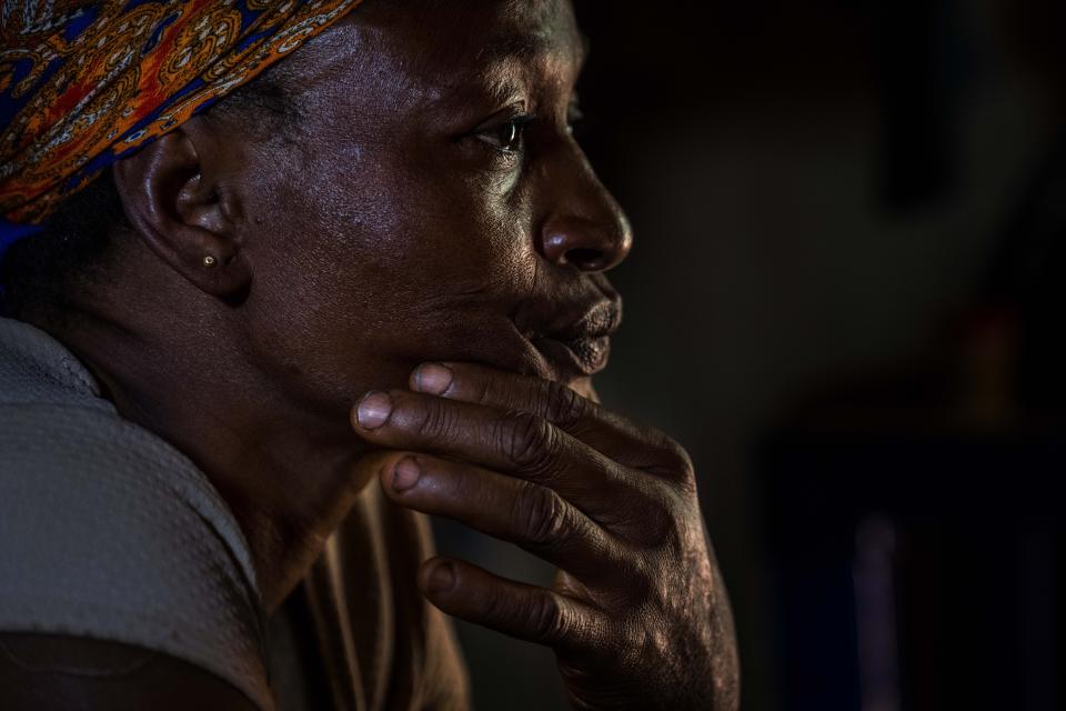 Roseline Ujah, 49, sits on her bed in Umuida, Nigeria, Friday, Feb. 11, 2022. Ujah's husband Godwin fell severely ill with a fever and cough. Everyone assumed at first that the palm wine tapper had contracted malaria, but then he failed to improve on medications for that disease. Doctors at a local hospital diagnosed him with COVID-19, though there were no tests available locally to confirm their suspicion. (AP Photo/Jerome Delay)