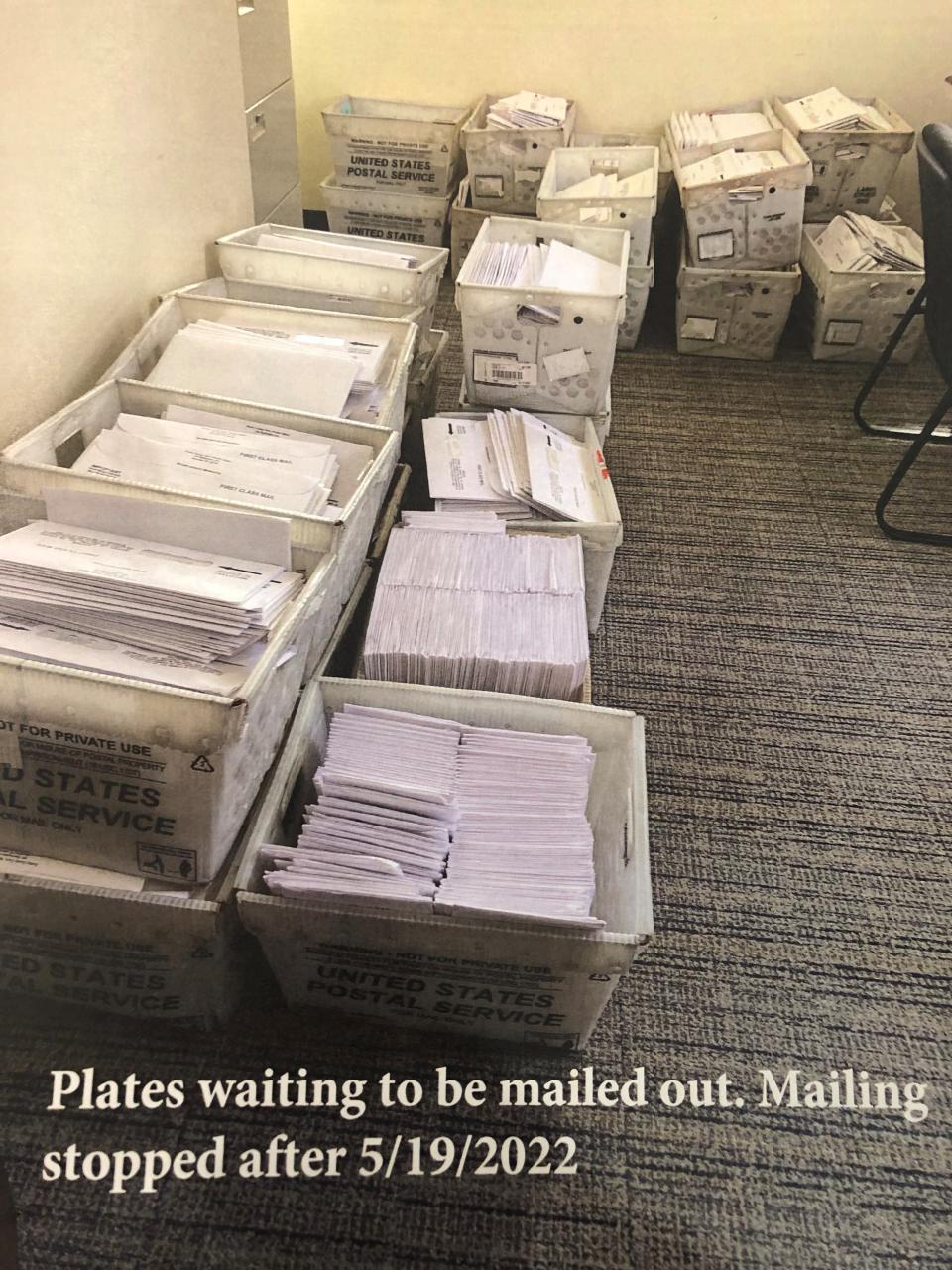 Photos handed out in Shelby County Commission Wednesday, June 1, show stacks of license plates ready to be mailed out in the Shelby County Clerk's Office.