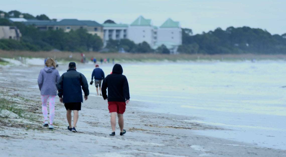 Beach goers don’t find much room while walking on Hilton Head Island on Thursday, Sept. 29, 2022, due to storm surge caused by tropical storm Ian as it advances up the coast.