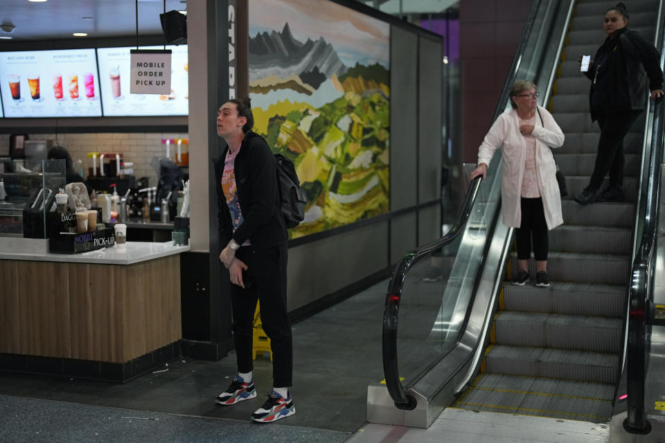 Breanna Stewart, left, of the New York Liberty WNBA basketball team waits for coffee after traveling for most of the day at Harry Reid International Airport while traveling with the team Wednesday, June 28, 2023, in Las Vegas. (AP Photo/John Locher)