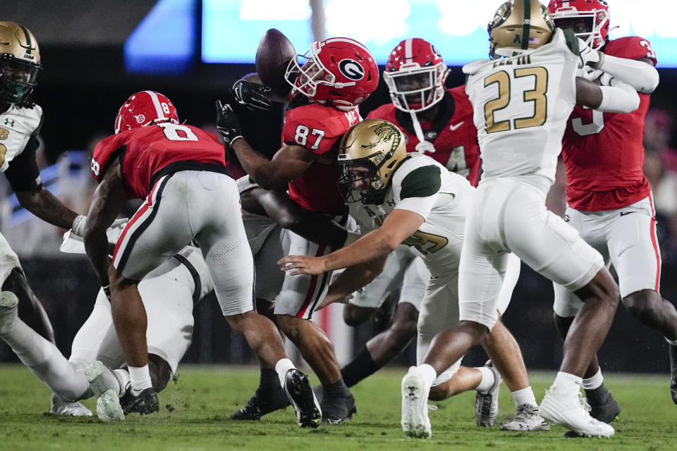 Georgia wide receiver Mekhi Mews (87) fumbles as he his hit by UAB long snapper Xander Echols (39) on a punt return during the first half of an NCAA college football game, Saturday, Sept. 23, 2023, in Athens, Ga. (AP Photo/John Bazemore)