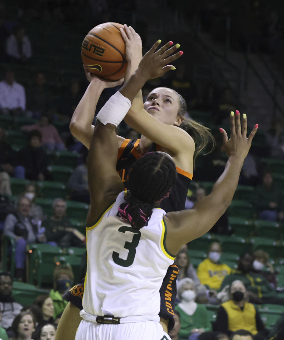 Oklahoma State guard Lexy Keys shoots over Baylor guard Jordan Lewis during the first half of an NCAA college basketball game Wednesday, Jan. 19, 2022, in Waco, Texas. (Rod Aydelotte/Waco Tribune-Herald via AP)