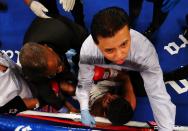 NEW YORK, NY - OCTOBER 20: Erik Morales is tended to by referee Benji Esteves after being knocked out in the fourth round by Danny Garcia during their WBC/WBA junior welterweight title at the Barclays Center on October 20, 2012 in the Brooklyn Borough of New York City. (Photo by Al Bello/Getty Images for Golden Boy Promotions)