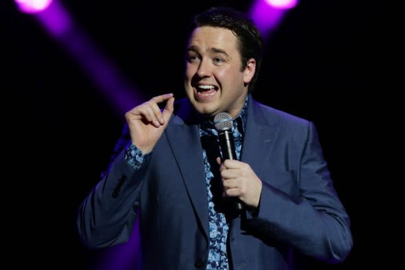 Jason Manford performing on stage